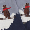 A close up of a  pair of children's socks with a skiing bear design, featuring a blue colour scheme.