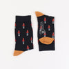 A pair of children's Christmas themed socks with a pattern of drummer boys.