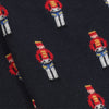 A pair of children's Christmas themed socks with a pattern of drummer boys.